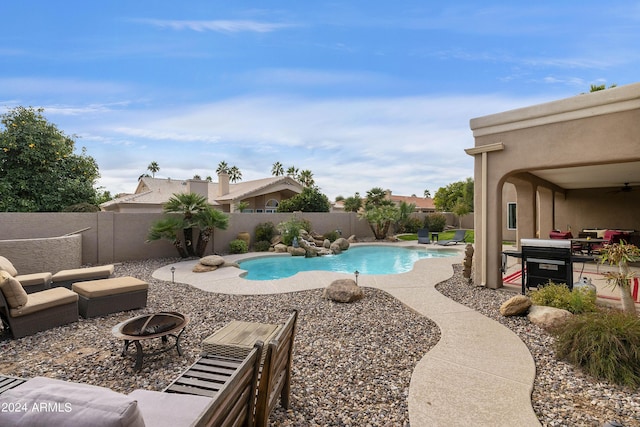 view of pool with a patio area and an outdoor fire pit