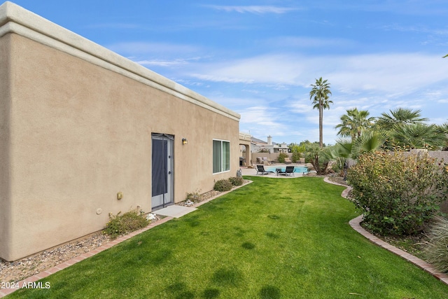 view of yard featuring a swimming pool and a patio