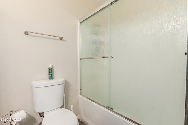 bathroom with toilet and enclosed tub / shower combo