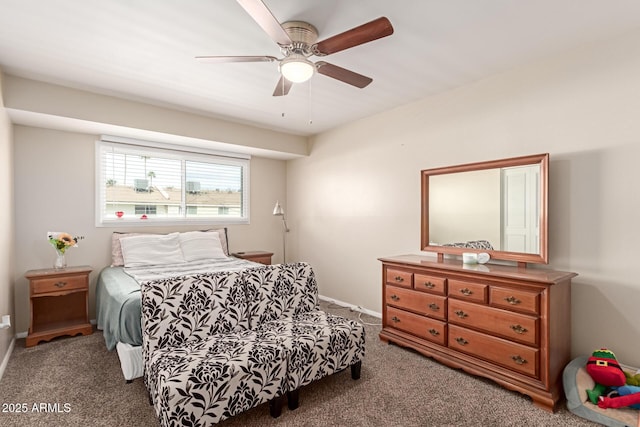 carpeted bedroom with a ceiling fan and baseboards