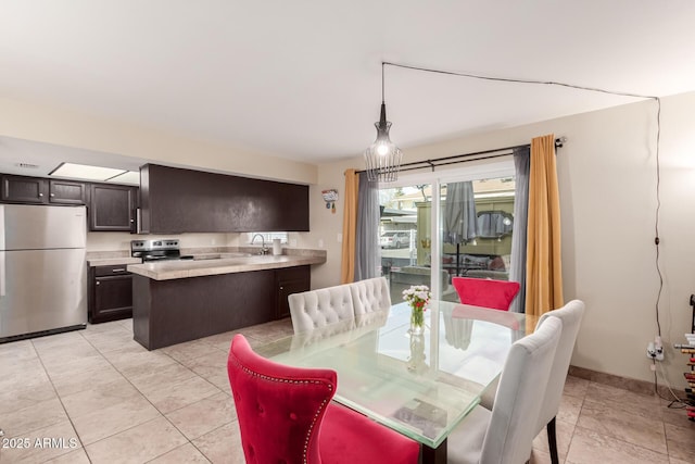 dining room featuring light tile patterned floors and baseboards