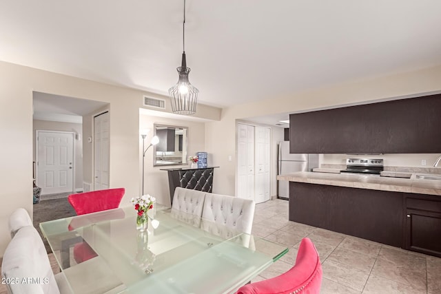 dining space with light tile patterned floors and visible vents