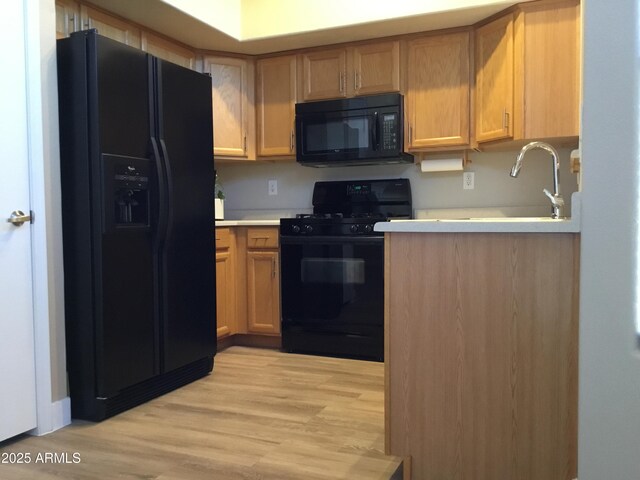 1827 E Carla Vista Dr, Gilbert, AZ 85295 - kitchen with black appliances, light countertops, light wood-type flooring, and a sink
