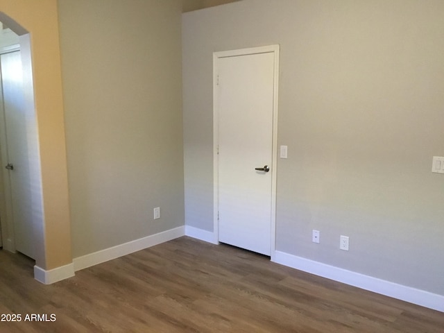1827 E Carla Vista Dr, Gilbert, AZ 85295 - unfurnished room with arched walkways, wood finished floors, and baseboards