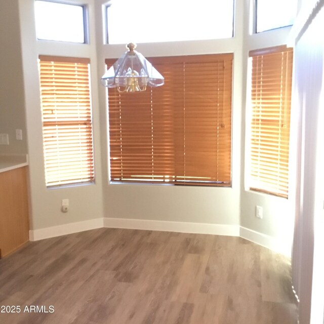1827 E Carla Vista Dr, Gilbert, AZ 85295 - unfurnished dining area with wood finished floors and baseboards