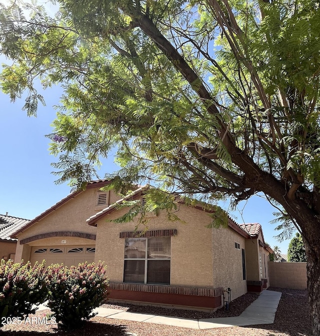 1827 E Carla Vista Dr, Gilbert, AZ 85295 - view of front facade with stucco siding, fence, a garage, and a tile roof
