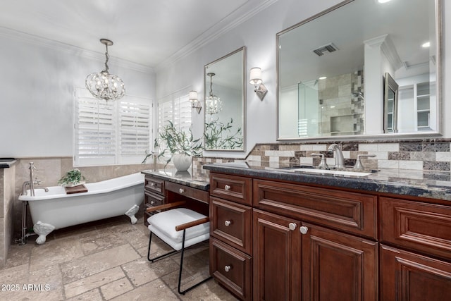 bathroom with plus walk in shower, a notable chandelier, vanity, tile walls, and ornamental molding