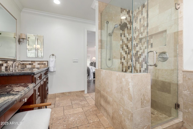 bathroom featuring vanity, backsplash, walk in shower, and crown molding