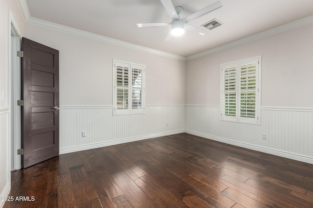 empty room with crown molding, ceiling fan, and dark wood-type flooring