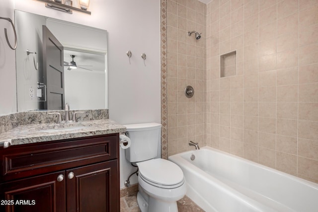 full bathroom featuring tiled shower / bath, vanity, toilet, and ceiling fan