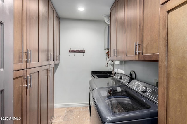 laundry area with washer and clothes dryer, sink, and cabinets