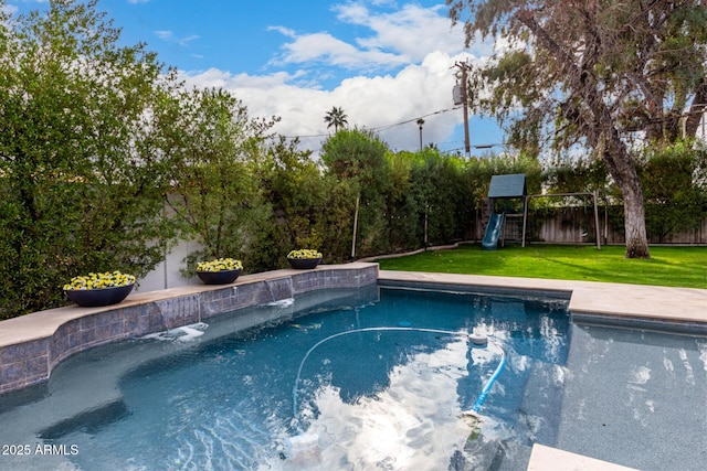 view of swimming pool with a playground and a yard