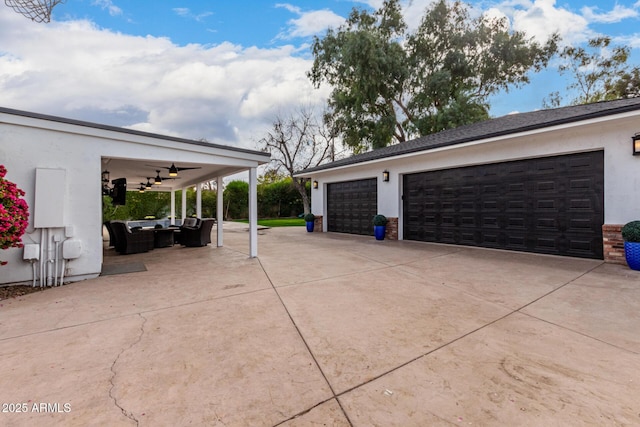 exterior space with ceiling fan and a garage