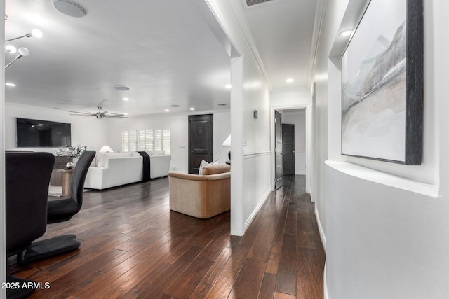 living room featuring ceiling fan, dark hardwood / wood-style flooring, and ornamental molding