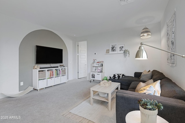 living area featuring visible vents and carpet floors