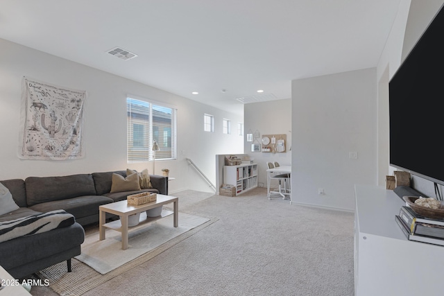 living area with recessed lighting, light colored carpet, visible vents, and baseboards