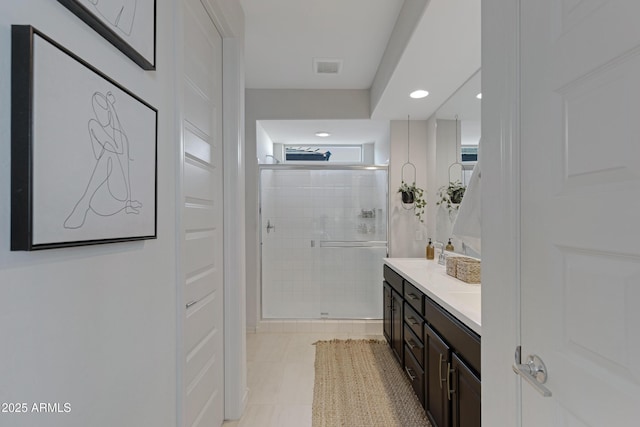 full bathroom with double vanity, visible vents, recessed lighting, and a shower stall