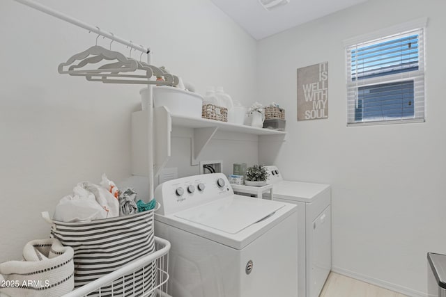 laundry room with laundry area, separate washer and dryer, and baseboards