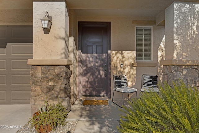 entrance to property featuring stucco siding