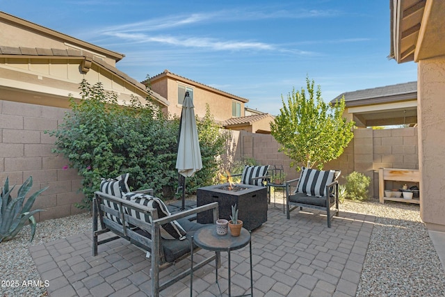 view of patio with a fenced backyard and an outdoor fire pit