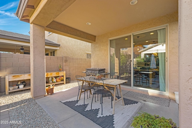 view of patio with outdoor dining area and fence