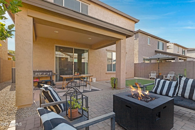 view of patio featuring a fire pit and fence