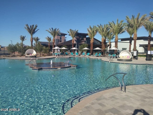 pool with a patio and fence