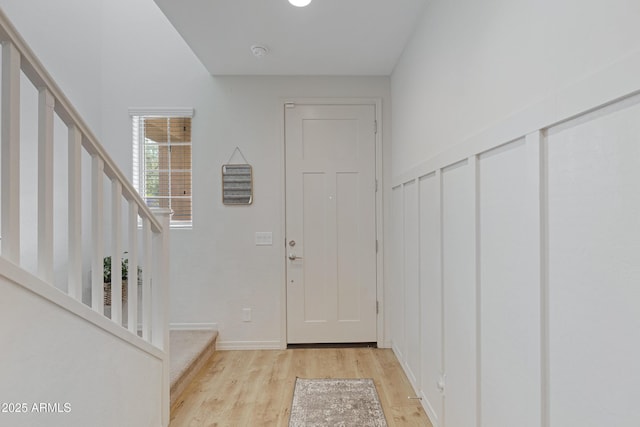 foyer with stairway and wood finished floors