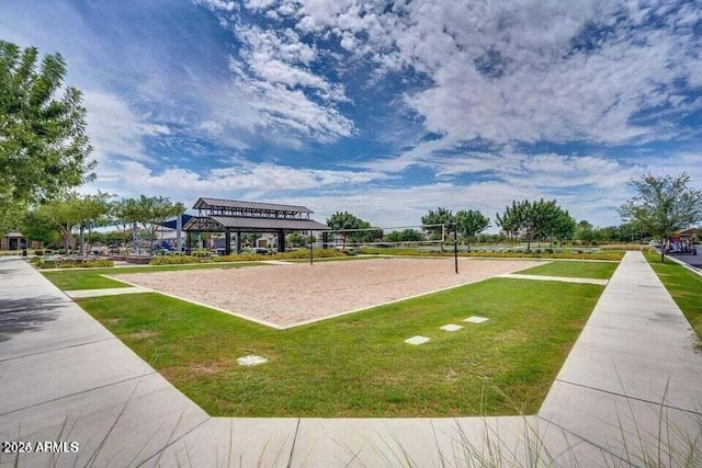 view of property's community featuring a lawn and volleyball court