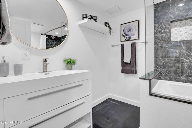 bathroom featuring tiled shower / bath combo and vanity