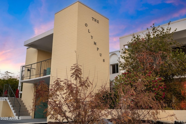 property exterior at dusk with a balcony