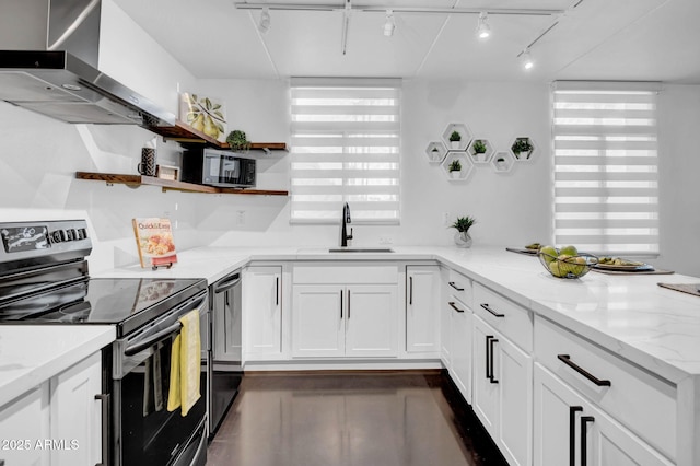 kitchen with sink, white cabinetry, electric stove, light stone countertops, and wall chimney range hood