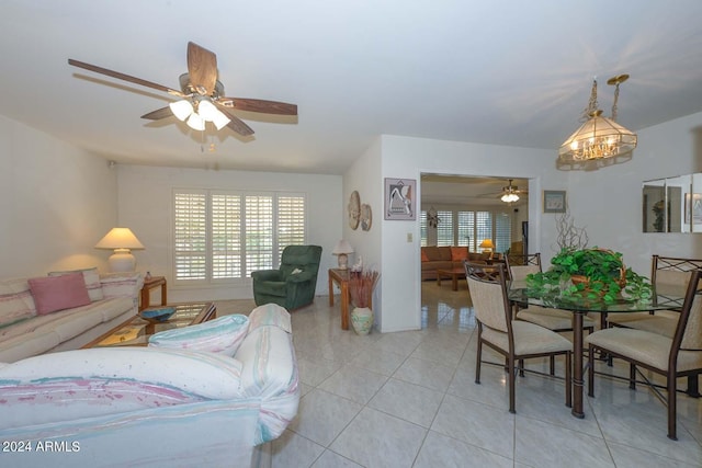 bedroom with light tile floors and ceiling fan with notable chandelier