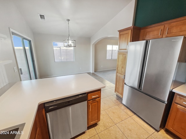 kitchen with a wealth of natural light, lofted ceiling, and appliances with stainless steel finishes