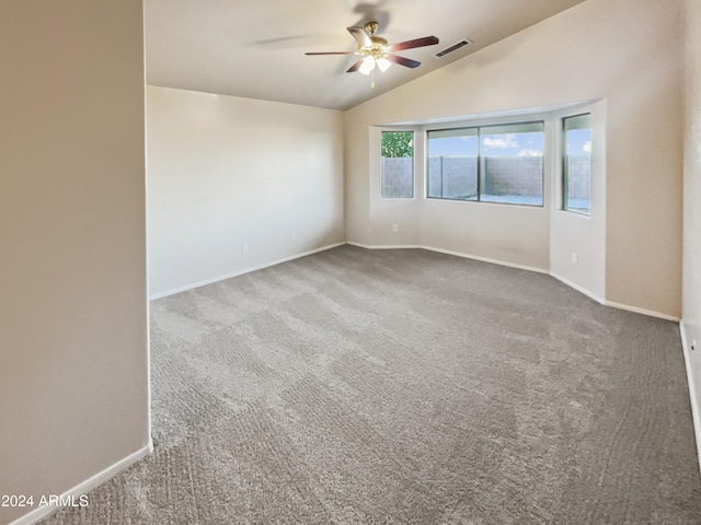 empty room with ceiling fan, carpet floors, and lofted ceiling