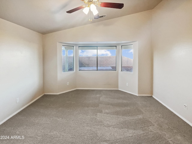 unfurnished room with carpet floors and vaulted ceiling