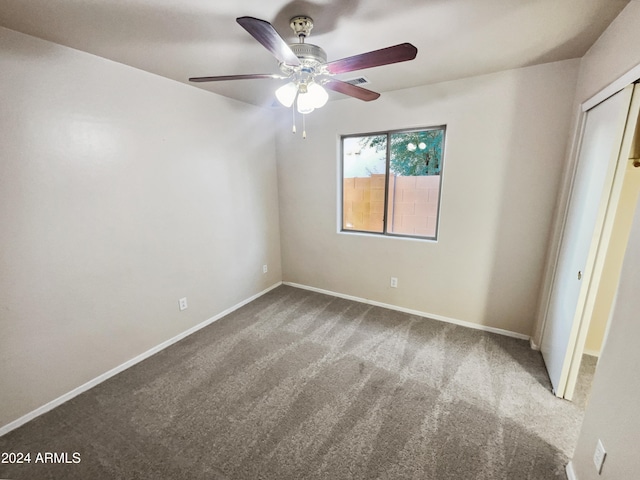 unfurnished bedroom with carpet flooring, ceiling fan, and a closet