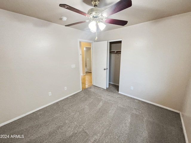 unfurnished bedroom with carpet, ceiling fan, and a closet