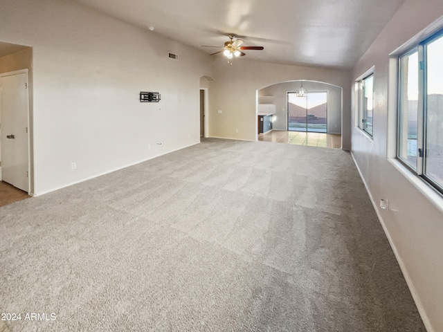 unfurnished living room with light carpet, ceiling fan, and lofted ceiling