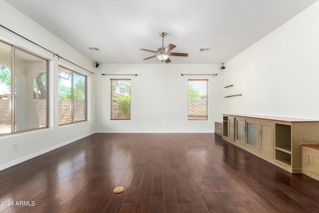 interior space featuring ceiling fan, plenty of natural light, and dark hardwood / wood-style flooring