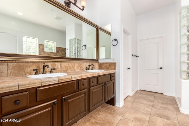 bathroom featuring vanity, tasteful backsplash, and tile patterned floors