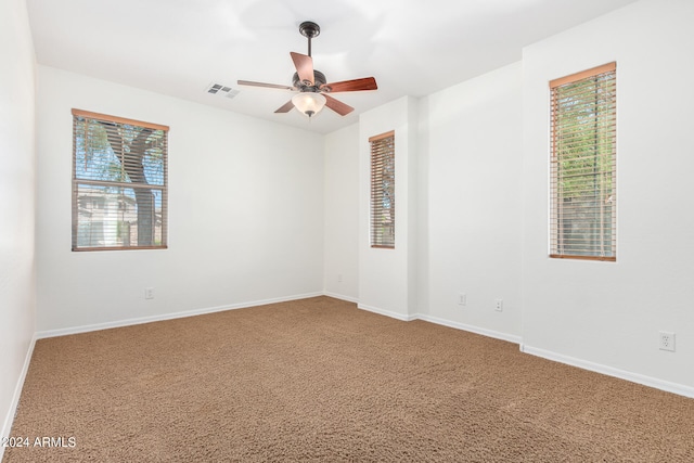 carpeted spare room with ceiling fan