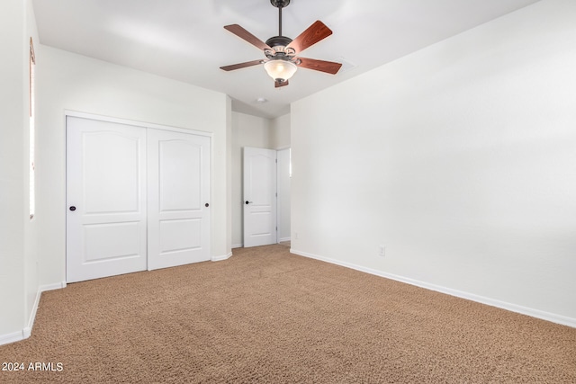 unfurnished bedroom with a closet, ceiling fan, and carpet floors