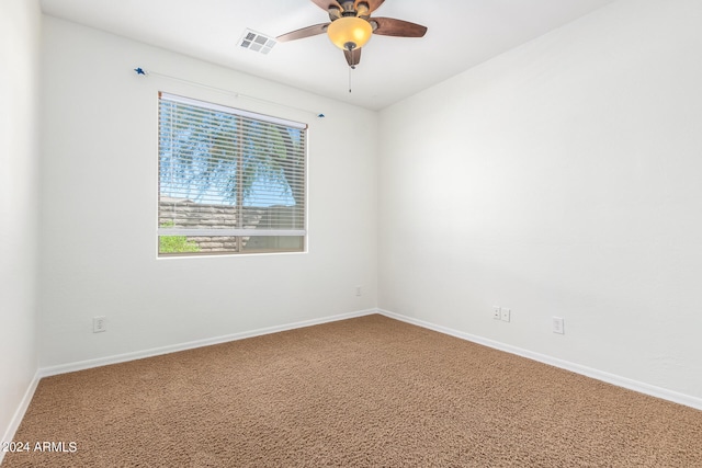 spare room featuring carpet and ceiling fan