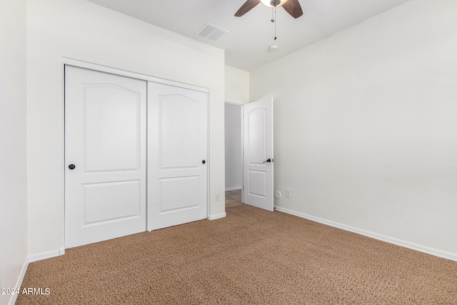 unfurnished bedroom with a closet, ceiling fan, and carpet flooring