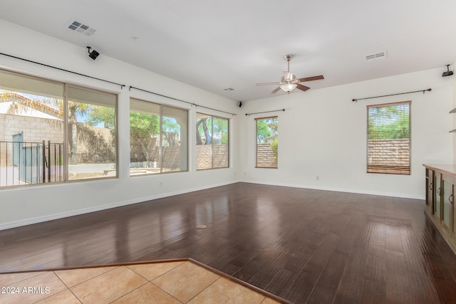 unfurnished living room featuring light hardwood / wood-style floors and ceiling fan