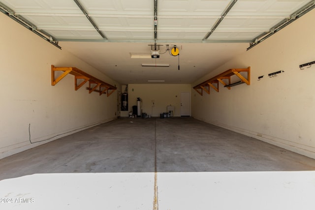 garage with strapped water heater and a garage door opener