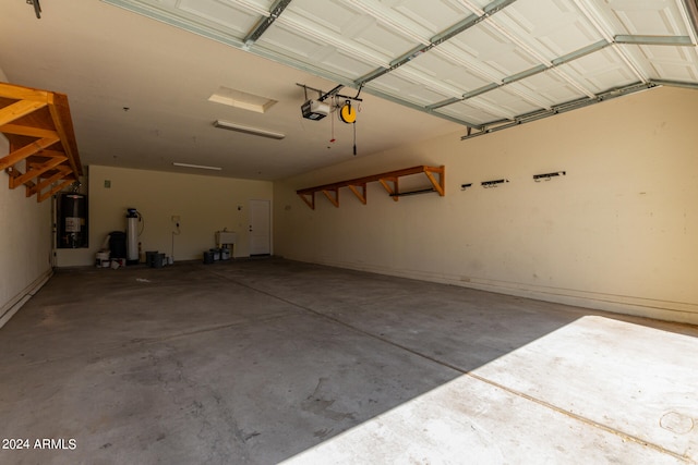 garage with a garage door opener and water heater