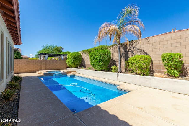 view of pool with an in ground hot tub and a patio