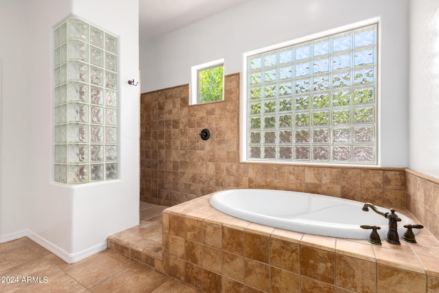 bathroom featuring shower with separate bathtub and tile patterned flooring